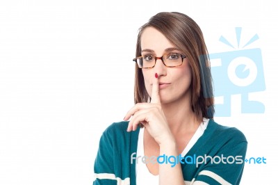 Beautiful Woman Holding Finger On Lips Stock Photo