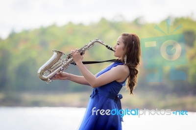 Beautiful Woman Wear Blue Evening Dress Sound Saxophone Over Mou… Stock Photo