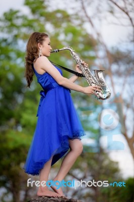 Beautiful Woman Wear Blue Evening Dress Sound Saxophone Stand On… Stock Photo