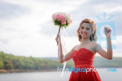 Beautiful Woman Wear Red Evening Dress Hold A Bouquet Of Flowers… Stock Photo