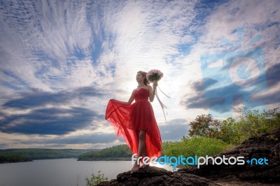 Beautiful Woman Wear Red Evening Dress Hold A Bouquet Of Flowers… Stock Photo