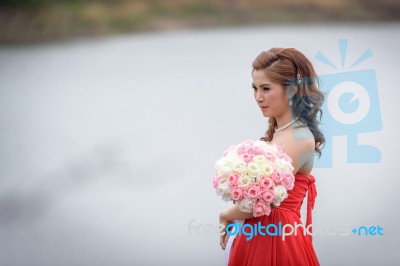 Beautiful Woman Wear Red Evening Dress Hold A Bouquet Of Flowers… Stock Photo