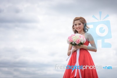 Beautiful Woman Wear Red Evening Dress Hold A Bouquet Of Flowers… Stock Photo