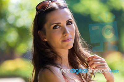 Beautiful Woman With Dark Hair And Brown Eyes Posing At Summer G… Stock Photo