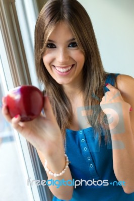 Beautiful Woman With Red Apple At Home Stock Photo