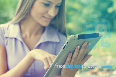 Beautiful Woman With Tablet Computer In Park Stock Photo