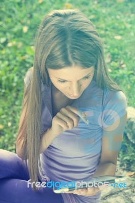 Beautiful Woman With Tablet Computer In Park Stock Photo