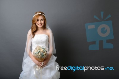 Beautiful Young Asian Bride In Wedding Dress With Flower Bouquet… Stock Photo