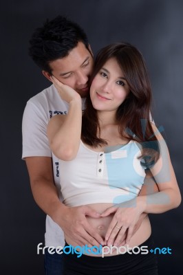 Beautiful Young Asian Couple Expecting Baby Stock Photo