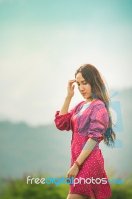 Beautiful Young Attractive  Asian Women In Red Dress On Sunrise Beautiful Nature Background Of The Mountains And Lotus Garden Image Of Happy  Camping, Travel, Lifestyle Resting , Relaxing Concept Vintage Style Stock Photo