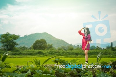 Beautiful Young Attractive  Asian Women In Red Dress On Sunrise Beautiful Nature Background Of The Mountains And Lotus Garden Image Of Happy  Camping, Travel, Lifestyle Resting , Relaxing Concept Vintage Style Stock Photo