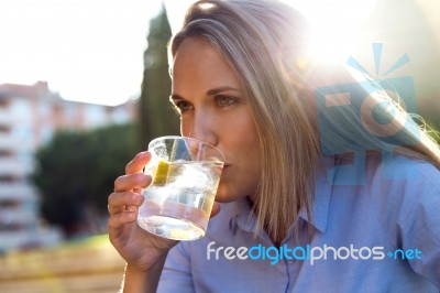 Beautiful Young Woman Drinking Soda In A Restaurant Terrace Stock Photo
