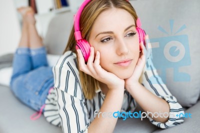 Beautiful Young Woman Listening To Music At Home Stock Photo