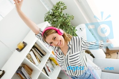 Beautiful Young Woman Listening To Music At Home Stock Photo