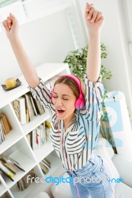 Beautiful Young Woman Listening To Music At Home Stock Photo