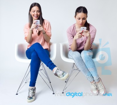 Beautiful Young Woman Using Her Mobile Phone At Home Stock Photo