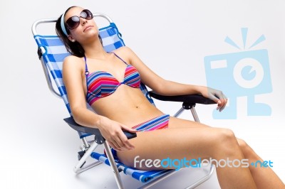 Beautiful Young Woman With Bikini Sitting On A Beach Chair Stock Photo Royalty Free Image Id 100361373