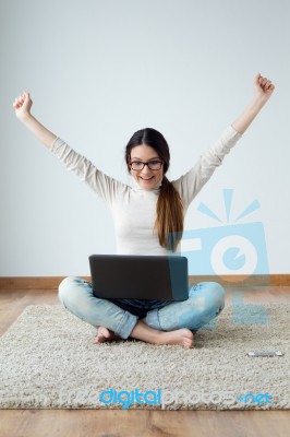 Beautiful Young Woman Working On Her Laptop At Home Stock Photo
