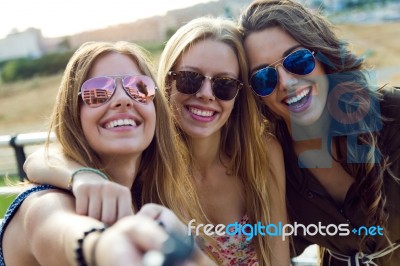 Beautiful Young Women Using Mobile Phone In The Street Stock Photo