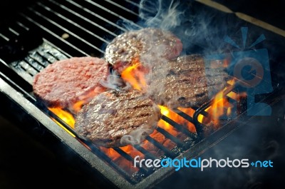 Beef Burgers On Barbeque Stock Photo