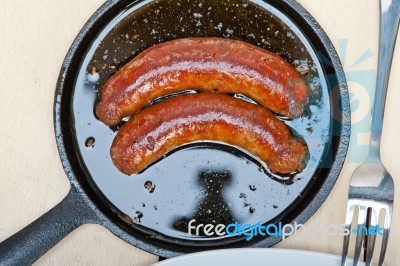 Beef Sausages Cooked On Iron Skillet Stock Photo