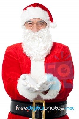 Bespectacled Father Santa Posing With Open Palms Stock Photo