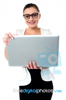 Bespectacled Woman Holding A Laptop Stock Photo