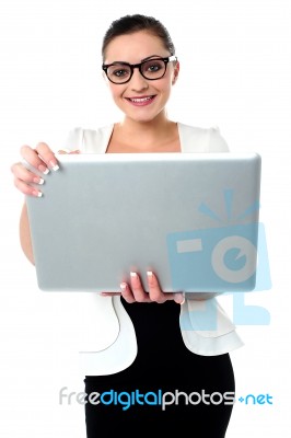 Bespectacled Woman Holding A Laptop Stock Photo