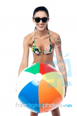 Bikini Clad Woman Playing With Beach Ball Stock Photo