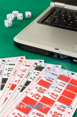 Bingo Cards On Casino Baize And A Laptop Stock Photo