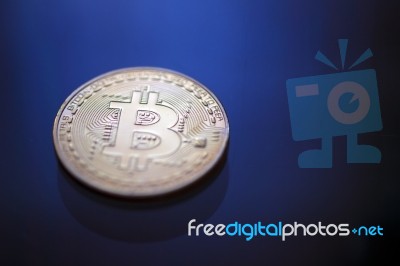 Bitcoin Coin On Blue Light Background Stock Photo
