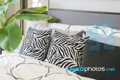 Black And White Pillows And Blanket On Modern Bed Stock Photo