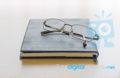 Black Book With Glasses Stock Photo