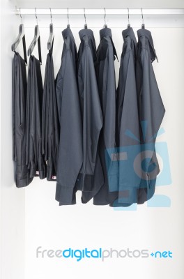 Black Clothes Hanging On Rail Stock Photo Black Clothes Hanging On Rail Stock Photo