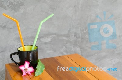
Black Coffee Cup On The Table Brown Wood Trim With Colorful Flo… Stock Photo