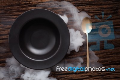 Black Empty Bowl Spoon On Wooden Table Background Stock Photo