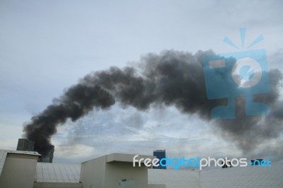 Black Smoke From Fire Burning On The Sky Stock Photo