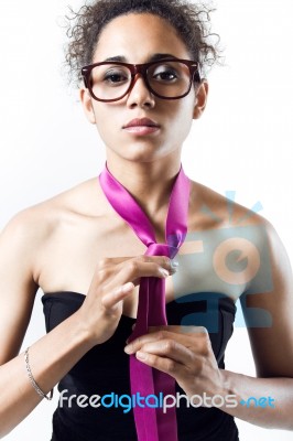 Black Woman In Evening Dress Playing With A Tie. Concept Of Domination And Authority Stock Photo