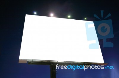 Blank Illuminated Billboard Over Evening Sky Stock Photo