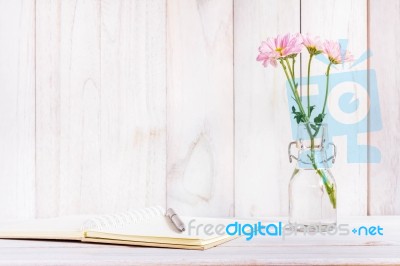Blank Notebook With Flower On White Wooden Table Stock Photo
