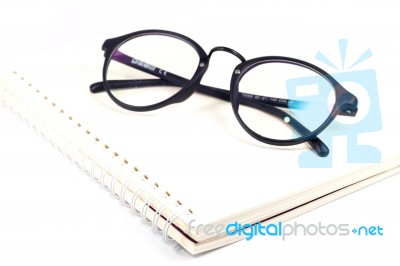 Blank Spiral Notebook And Eyeglasses Isolated On White Background Stock Photo