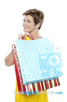 Blonde With Shopping Bags Tossed Over Her Shoulders Stock Photo