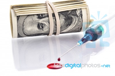 Blood Drops From Syringe Needle With 100 Dollars Banknotes In Background Stock Photo