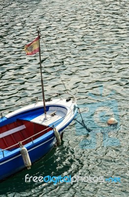 Blue Boat With Flag Stock Photo