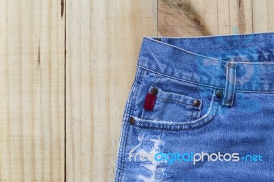 Blue Jean Skirt Design On Wood Background Stock Photo