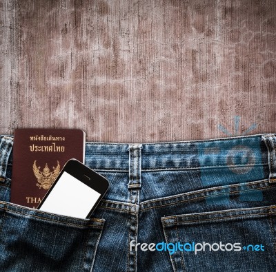 Blue Jeans With Cell Phone And Passport In A Pocket Background Stock Photo