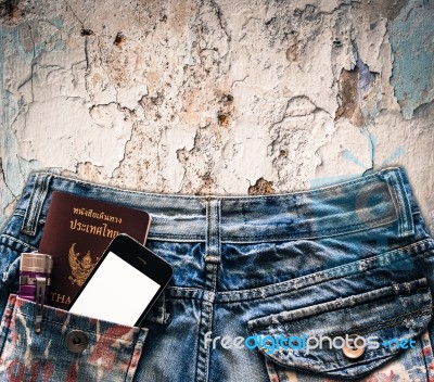 Blue Jeans With Cell Phone, Flashlight And Passport In A Pocket Stock Photo