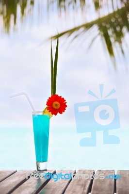 Blue Lagoon Cocktail On The Table At Tropical Beach Stock Photo