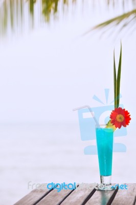 Blue Lagoon Cocktail On The Table At Tropical Beach Stock Photo