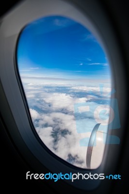 Blue Sky White Cloud ,looking Through Airplane Window Frame Stock Photo